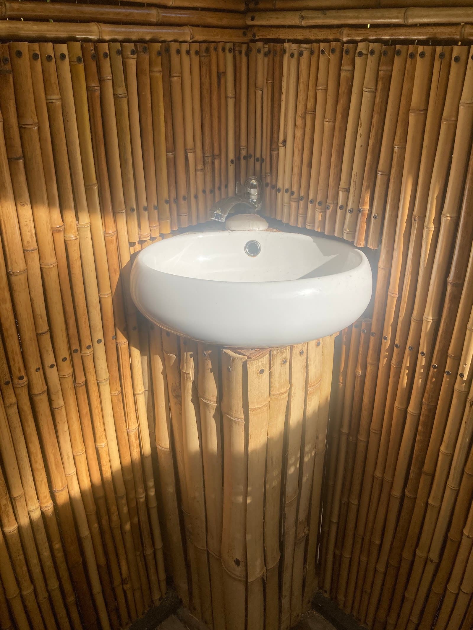 Open-air bamboo bathroom detail