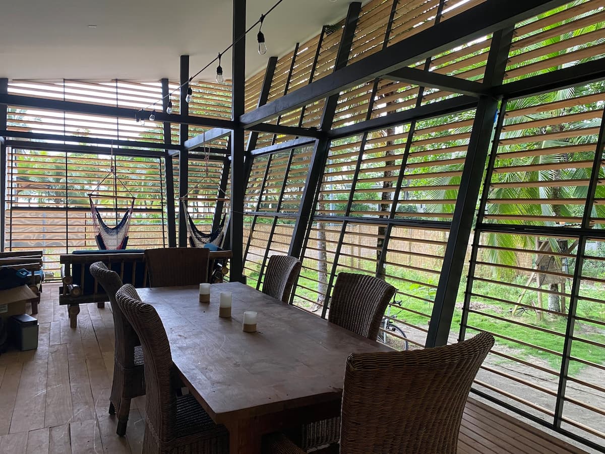 The long dining table in the No-Footprint House, open to the garden