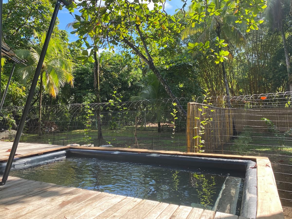 A deep plunge pool built into the deck of a safari tent