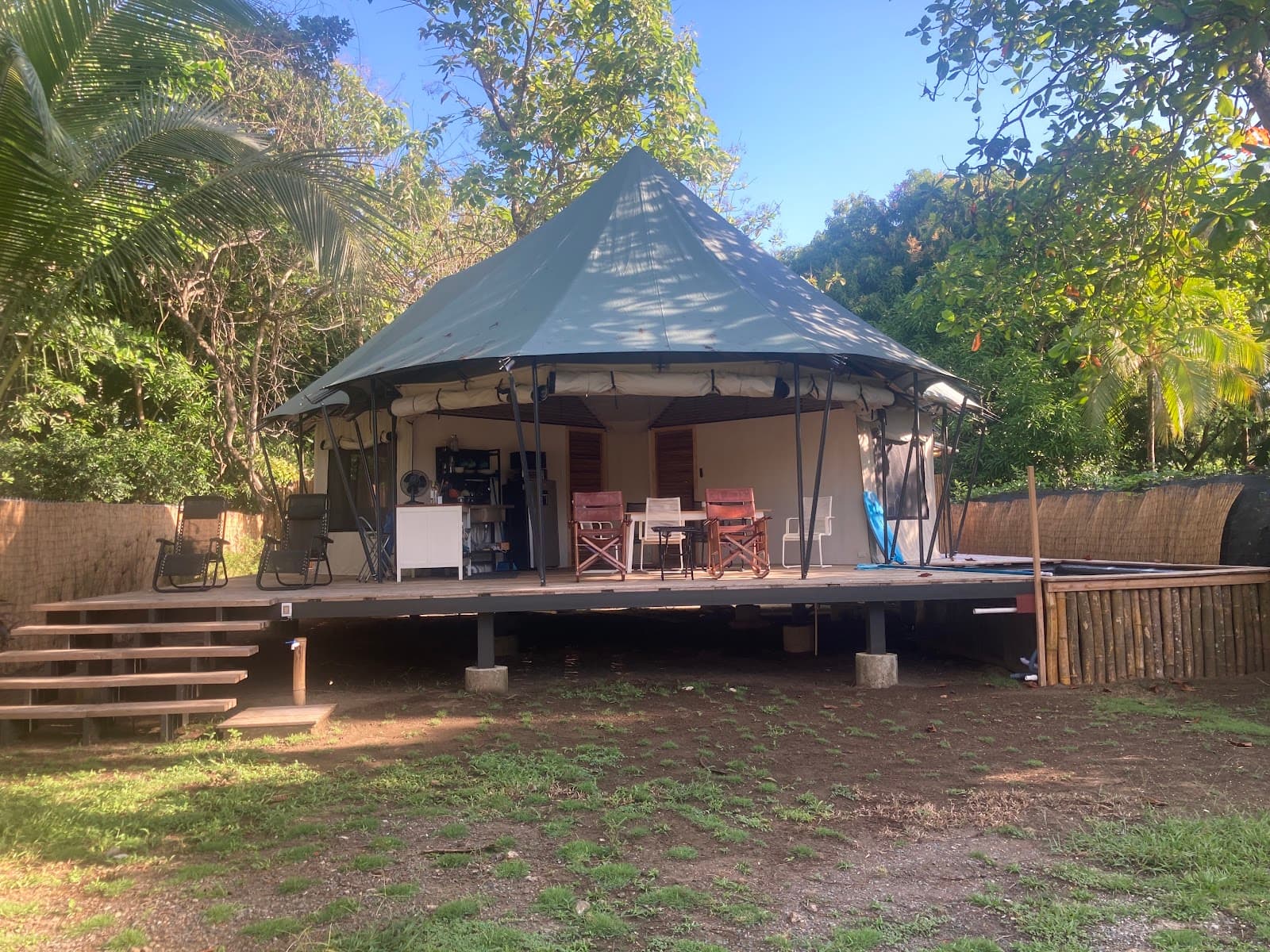 A safari tent in canvas and steel, set in the garden