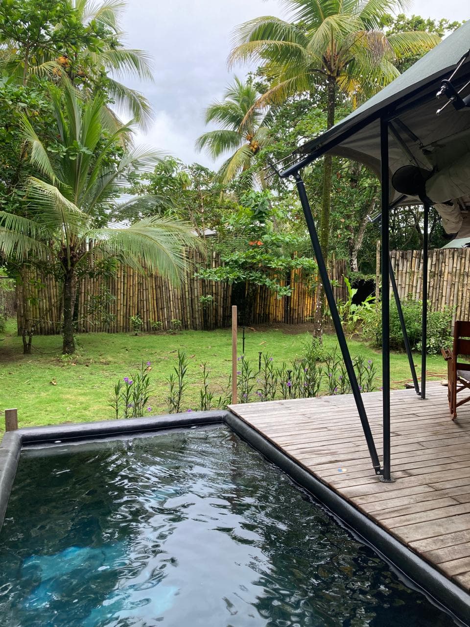 A plunge pool built into the tent deck, looking out over the garden